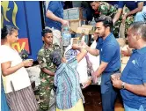  ??  ?? Arpico CSR team distribute­s care packages to families in affected areas