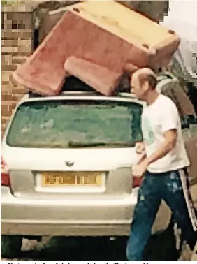  ?? Dorset Police ?? > Photograph of a sofa being carried on the Skoda car of former Superinten­dent Michael Rogers