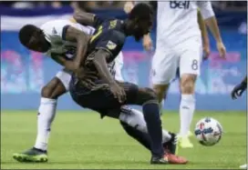  ?? DARRYL DYCK — THE CANADIAN PRESS VIA AP ?? The Union’s Derrick Jones, right, tangles with Whitecaps midfielder Alphonso Davies Sunday night in a 0-0 draw in Vancouver. Making his MLS debut, Jones was impressive for his poise in midfield.