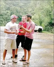  ?? Brandon Howard/NWA Democrat-Gazette ?? Tim Stolt, left, of Bella Vista, Dallas Doty of Springdale, and Todd Verrone of Bentonvill­e discuss their plan for riding the newly opened 15-mile segment of the Back 40 Loop mountain bike trail in Bella Vista on Sunday. A heavy downpour wet the trail,...