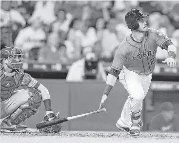  ?? Karen Warren photos / Houston Chronicle ?? In his first game back in the majors, Astros designated hitter Preston Tucker rips a triple to center in the fifth inning. He went on to score the game’s first run Friday night.