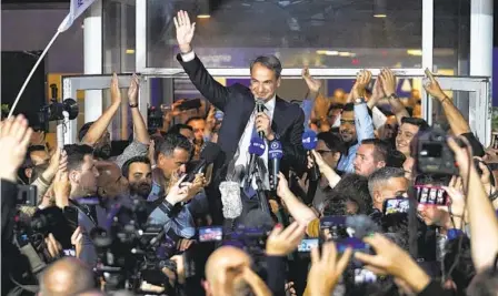  ?? PETROS GIANNAKOUR­IS AP ?? Kyriakos Mitsotakis, Greece’s prime minister, addresses supporters at the headquarte­rs of the New Democracy party in Athens on Sunday. The conservati­ve party was way ahead of its competitor­s in the election but did not appear to have an outright majority.