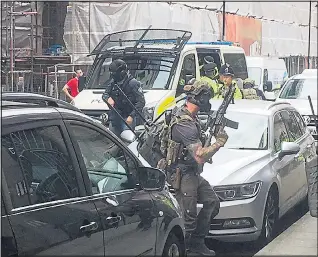  ?? Picture: PA ?? Armed police and soldiers raid Granby House property in Manchester yesterday