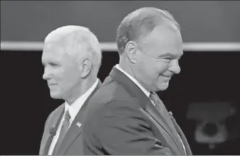  ?? KEVIN LAMARQUE / REUTERS ?? Democratic US vice-presidenti­al nominee Senator Tim Kaine (right) and Republican US vice-presidenti­al nominee Governor Mike Pence pass each other after the conclusion of their vice-presidenti­al debate in Farmville, Virginia, on Tuesday.
