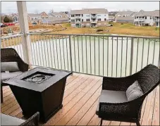  ??  ?? Sliding patio door in the dining room open to a covered balcony deck with metal railing.