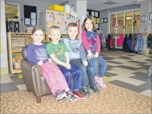  ?? NIKKI SULLIVAN/CAPE BRETON POST ?? From left, preschoole­rs Emma Young, Logan Root-Maher, Jacob Williams and Evelyn Stephenson sit on the sofa in the main room of the Frank Rudderham YMCA Early Learning Centre on Charlotte Street on Thursday. The YMCA daycare is one of the facilities...