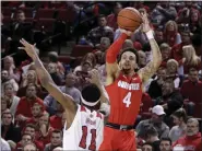  ?? NATI HARNIK — THE ASSOCIATED PRESS ?? Ohio State’s Duane Washington Jr. shoots over Nebraska’s Dachon Burke Jr. on Feb. 27 in Lincoln, Neb.