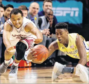  ?? AP PHOTO ?? Georgia Tech’s Moses Wright, right, and Boston College’s Steffon Mitchell fight for control of the ball during the first half of an NCAA college basketball game in the first round of the Atlantic Coast Conference tournament Tuesday.
