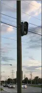  ?? MORNING JOURNAL FILE ?? A traffic camera keeps a watchful eye over traffic near the intersecti­on of Leavitt Road and a driveway into Lighthouse Village shopping center in 2019.