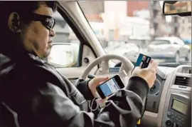  ?? Peter DaSilva ?? CAB DRIVER David Kahn in San Francisco uses Square to collect fares. Mobile payments are going mainstream as the use of smartphone­s and tablets grows.