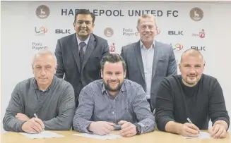  ??  ?? New chairman Raj Singh (back, left) and director of football Craig Hignett look on as first-team coach Ged McNamee, manager Matthew Bates and goalkeepin­g coach Ross Turnbull sign their deals at Hartlepool United.