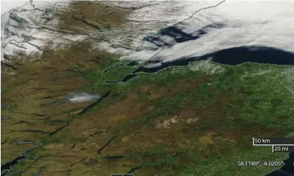  ?? Photograph: Nasa/PA ?? A Nasa worldview satellite photograph shows the plume of smoke from the fire at Cannich, in the hills above Loch Ness in the Highlands, drifting towards the loch on Monday.