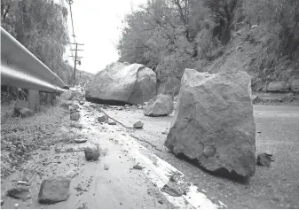  ?? MIKE NELSON, EPA ?? Boulders block Topanga Canyon Boulevard in California­Monday after torrential rain unleashed flooding and landslides.