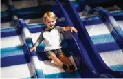  ?? Michael Minasi / Houston Chronicle ?? Barrett Dyson, 2, flies down a slide on Monday, Nov. 6, 2017, at Kanga’s Indoor Playcenter in The Woodlands.