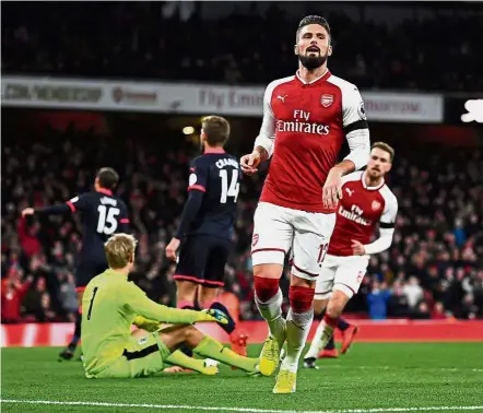  ?? — Reuters ?? Down and out: Arsenal’s Olivier Giroud reeling away after scoring against Huddersfie­ld at the Emirates.