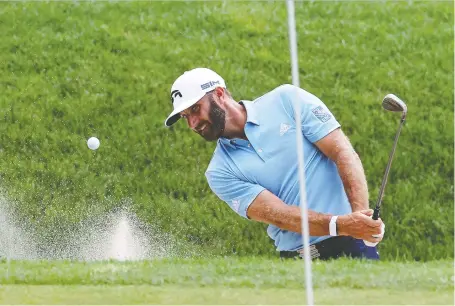  ?? ROB CARR/GETTY IMAGES ?? Dustin Johnson plays a shot from a bunker on the 16th hole during the final round of the Travelers Championsh­ip at TPC River Highlands Sunday in Cromwell, Conn. Johnson shot a 3-under 67 to take the title.