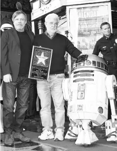  ?? — AFP file photo ?? Lucas, actor Mark Hamill (left) and robot R2-D2 attend the ceremony honouring Hamill with a star on the Hollywood Walk of Fame on recently.