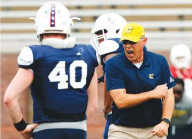  ?? STAFF PHOTO BY DOUG STRICKLAND ?? New head coach Rusty Wright shouts at players during UTC’s spring football scrimmage at Finley Stadium on March 30. The Mocs began preseason practice Wednesday night.