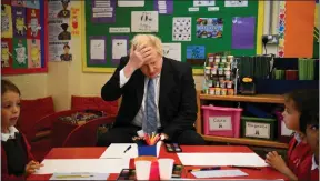  ?? ?? Boris Johnson during a visit to Field End Infant school, in South Ruislip, yesterday as hundreds of Tory councillor­s lost their seats as Labour and Libdems made gains