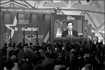  ?? SZILARD KOSZTICSAK / MTI VIA AP ?? Tucker Carlson delivers a speech May 19 at the CPAC conference in Budapest, Hungary.