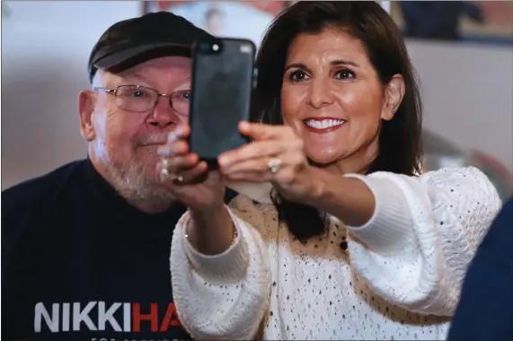  ?? NANCY LANE — BOSTON HERALD ?? Nikki Haley takes a selfie with a supporter at the Poor Boys Diner in Londonderr­y, N.H., yesterday.