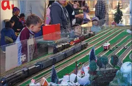  ?? PHOTOS BY ARIC SLEEPER — SANTA CRUZ SENTINEL ?? Model trains serve as a timeless draw for kids of all ages.