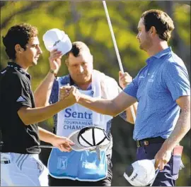  ?? Matthew Thayer Associated Press ?? THE CAREER turnaround of Harris English, right, greeting Joaquin Niemann, was complete with English’s playoff win, which placed him No. 17 in the world.