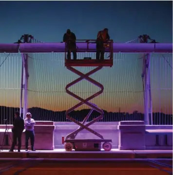  ?? COLE BURSTON/TORONTO STAR ?? Lighting technician­s put final touches on coloured lights on the Prince Edward Viaduct during a test run on Tuesday.