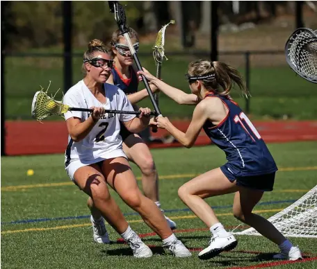  ?? STuART CAHiLL pHOTOs / HERALd sTAFF ?? STICK WORK: NDA’s Isabela Taylor, left, cuts away from Walpole’s Elyse Saus during the Cougars’ 11-8 win on Wednesday. Below, NDA’s Alexa Kenney is bracketed by Walpole’s Haley Brigham, left, and Emma Caufield.
