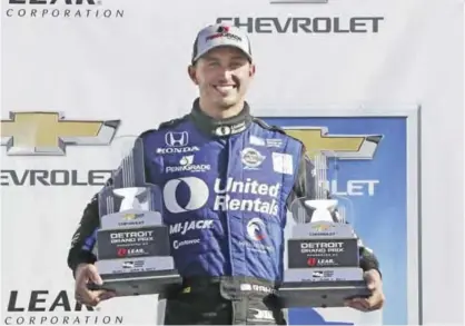  ??  ?? BELLE ISLE: Graham Rahal holds the trophies from the IndyCar Detroit Grand Prix auto race doublehead­er on Belle Isle, Sunday, in Detroit. Rahal completed a doublehead­er sweep in the race to become IndyCar’s first two-time winner this season. Rahal’s...
