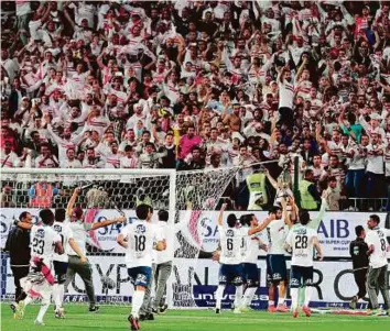  ?? AFP ?? Zamalek’s players celebrate with the trophy in front of their fans after clinching the Egyptian Super Cup final against Al Ahly in Abu Dhabi on Friday.