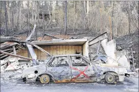  ?? MICHAEL PATRICK/KNOXVILLE NEWS SENTINEL ?? A burnt vehicle sits on a wildfire-damaged property in Gatlinburg, Tenn., on Friday, the first day residents were allowed back in following the devastatin­g fires that ravaged the area Monday night.