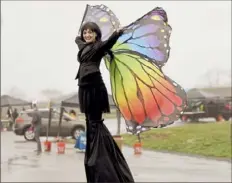  ?? Pam Panchak/Post-Gazette ?? Stilt walker Dr. Boogie brightens up a cloudy, gray day at the end of the Bunny Hop Trail — a drive-thru visit with the Easter Bunny and friends — on Wednesday at Fairview Park in South Fayette.