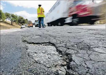  ?? Mark Boster
Los Angeles Times ?? CALTRANS SUPERVISOR Howard Mead stands amid cracked pavement near the 5 and 60 Freeways. During the last budget crisis, lawmakers plugged budget holes with fees intended for road repairs.