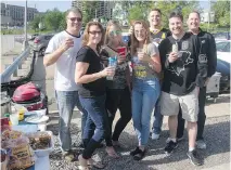  ?? PHOTOS: BRUCE DEACHMAN ?? Dave Stonebrake­r, at left above, hosts tailgate parties at Penguins games. Joining him Saturday were, from left, Carol Stonebrake­r, Alyssa Stonebrake­r, Lea Chrisman, Ryan McCandless, Jeremy Patora and Brian Little. The golden clock, right, outside what...