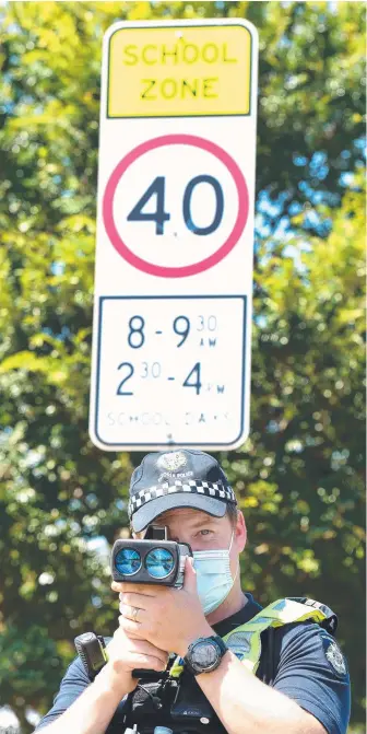  ?? Picture: David Smith ?? Senior Constable Adam Clay keeps tabs on speeding drivers outside Mirripoa Primary School in Mount Duneed.