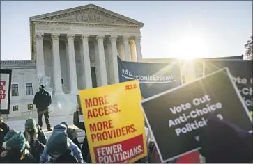  ?? Photograph­s by Kent Nishimura Los Angeles Times ?? ABORTION rights advocates demonstrat­e at the Supreme Court as the justices consider a Mississipp­i case.