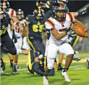  ?? STAFF PHOTO BY TROY STOLT ?? Lafayette quarterbac­k Jaylon Ramsey sprints through North Murray’s defense during last Friday’s GHSA Region 6-AAA matchup to close the regular season in Chatsworth, Ga.