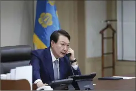  ?? (AP/South Korea Presidenti­al Office) ?? South Korean President Yoon Suk Yeol talks on the phone Thursday with Japanese Prime Minister Fumio Kishida in Seoul, South Korea as the two leaders agreed that North Korea’s recent missile tests are “a serious, grave provocatio­n” that threatens internatio­nal peace.