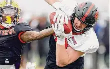  ?? Butch Dill/Associated Press ?? American tight end Luke Musgrave of Oregon State catches a pass over American defensive back Jay Ward of LSU during practice for the Senior Bowl on Thursday in Mobile, Ala.