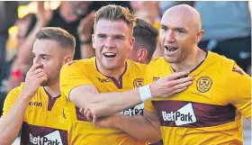  ??  ?? Conor Sammon, right, celebrates after giving Motherwell a 2-0 lead over Queen of the South with his second goal.