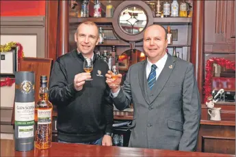  ??  ?? Glen Scotia manager Iain McAlister, and Machrihani­sh Golf Club captain Willie Ross celebrate the funding boost.