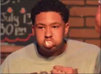  ?? PAUL DICICCO — THE NEWS-HERALD ?? Brush’s Justin Grigsby competes in The News-Herald/Varsity Chalk Talk hot dog eating contest July 16 at Hooley House in Mentor.