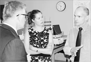  ??  ?? Michael Gibson, right, and fellow Holland College bioscience technology instructor Jennifer Slemmer talk Tuesday about the program’s facility with Gerald Keddy, parliament­ary secretary to the Minister of National Revenue.