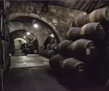  ?? ALBERT STUMM, THE ASSOCIATED PRESS ?? The warehouse at the Croft port wine house in Vila Nova de Gaia, Portugal. The stone building, which is dug into the side of a hill, keeps hundreds of wine barrels that age for up to 40 years.