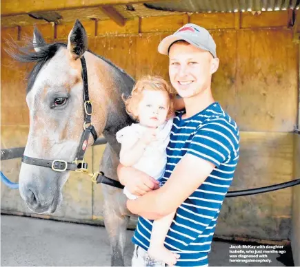  ??  ?? Jacob McKay with daughter Isabelle, who just months ago was diagnosed with hemimegale­ncephaly.