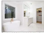  ?? ?? The primary bath features dual single-sink vanities, a step-in shower, a water closet and a soaking tub.