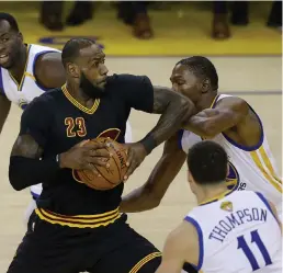  ?? — AFP ?? LeBron James (left) has been well below his lofty standards in the finals so far with the Warriors doing their best to negate his influence in the game.