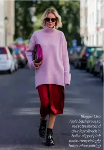  ??  ?? Blogger Lisa Hahnbück proves a red satin skirt and chunky rollneck in ballet-slipper pink make a surprising­ly harmonious pairing