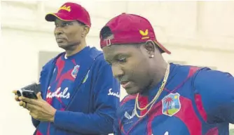  ?? (Photo: CWI Media) ?? West Indies chief selector Roger Harper (left) and all-rounder Rovman Powell during a recent indoor practice session in New Zealand.